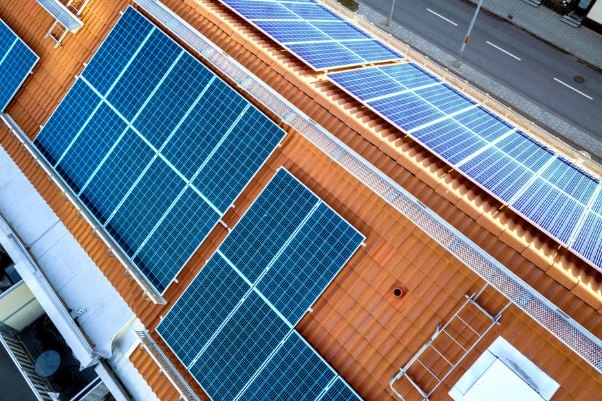 top-view-blue-solar-panels-high-apartment-building-roof